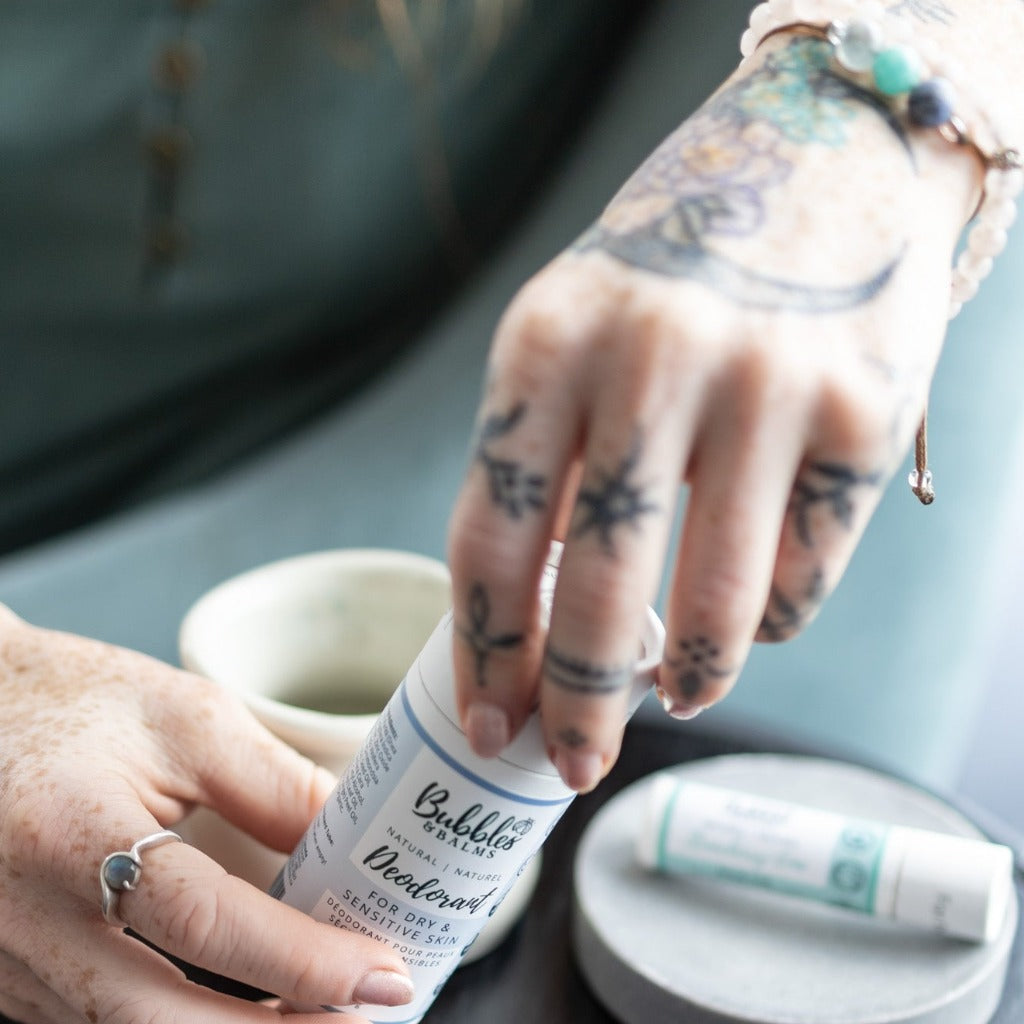 The cap easily pulls off of the top of the compostable cardboard tube Bubbles & Balms uses for their sensitive skin-friendly, vegan deodorants, as shown in this picture.