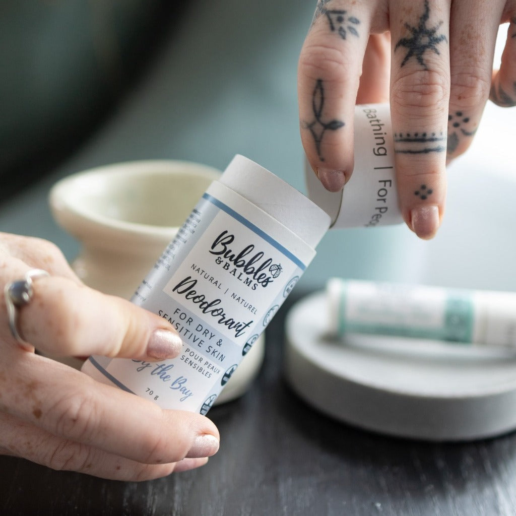 Cap being taken off of compostable packaging of natural and vegan deodorant from Bubbles & Balms.
