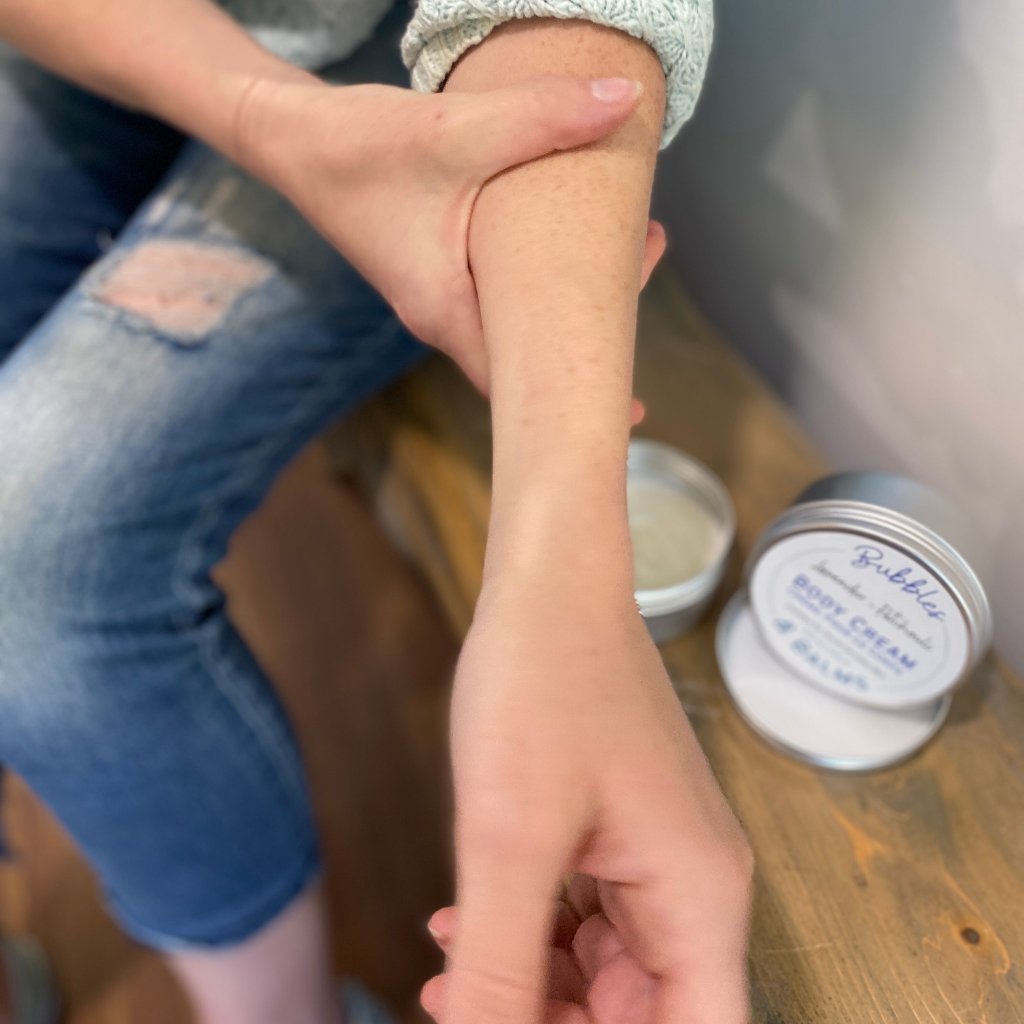 Bubbles & Balms body cream fully absorbed into a woman&