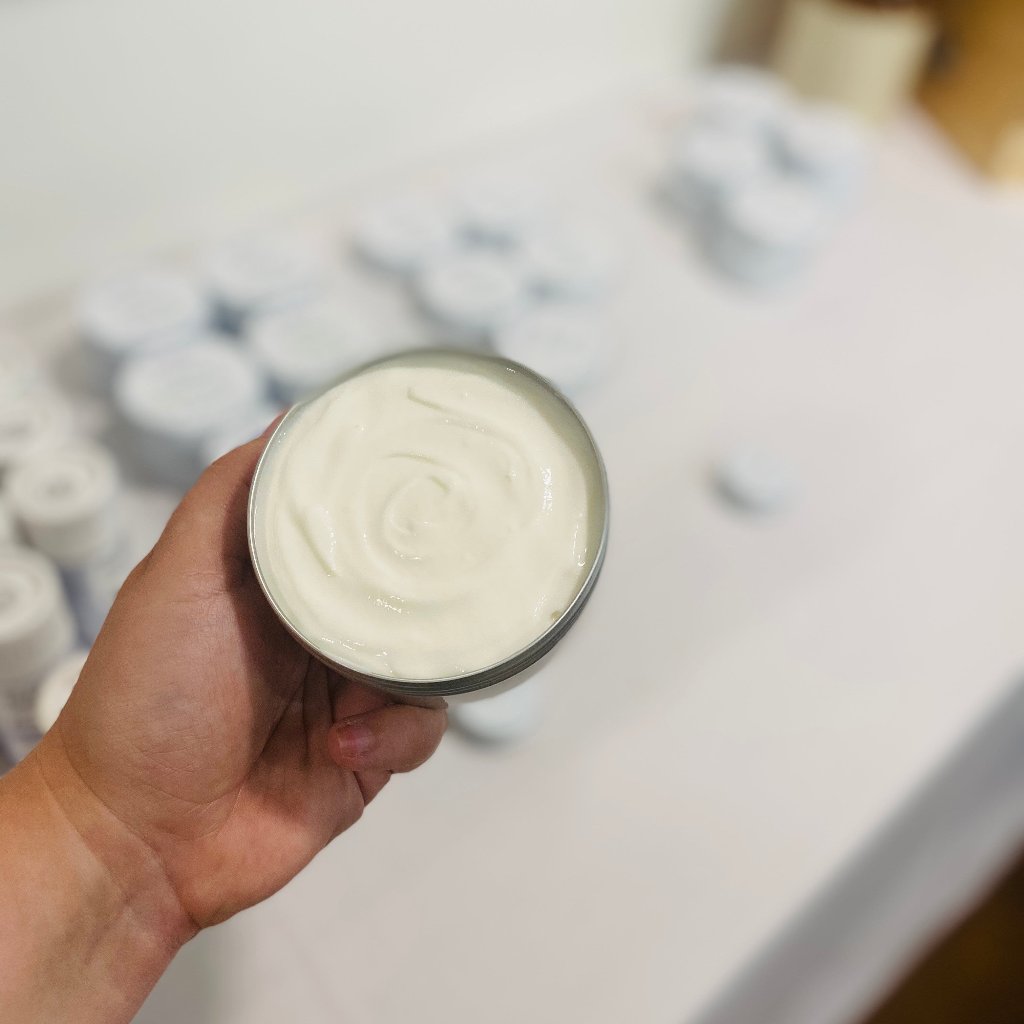 Bubbles & Balms body cream for dry & sensitive skin shown with a pleasant swirl in its plastic-free, aluminum tin.
