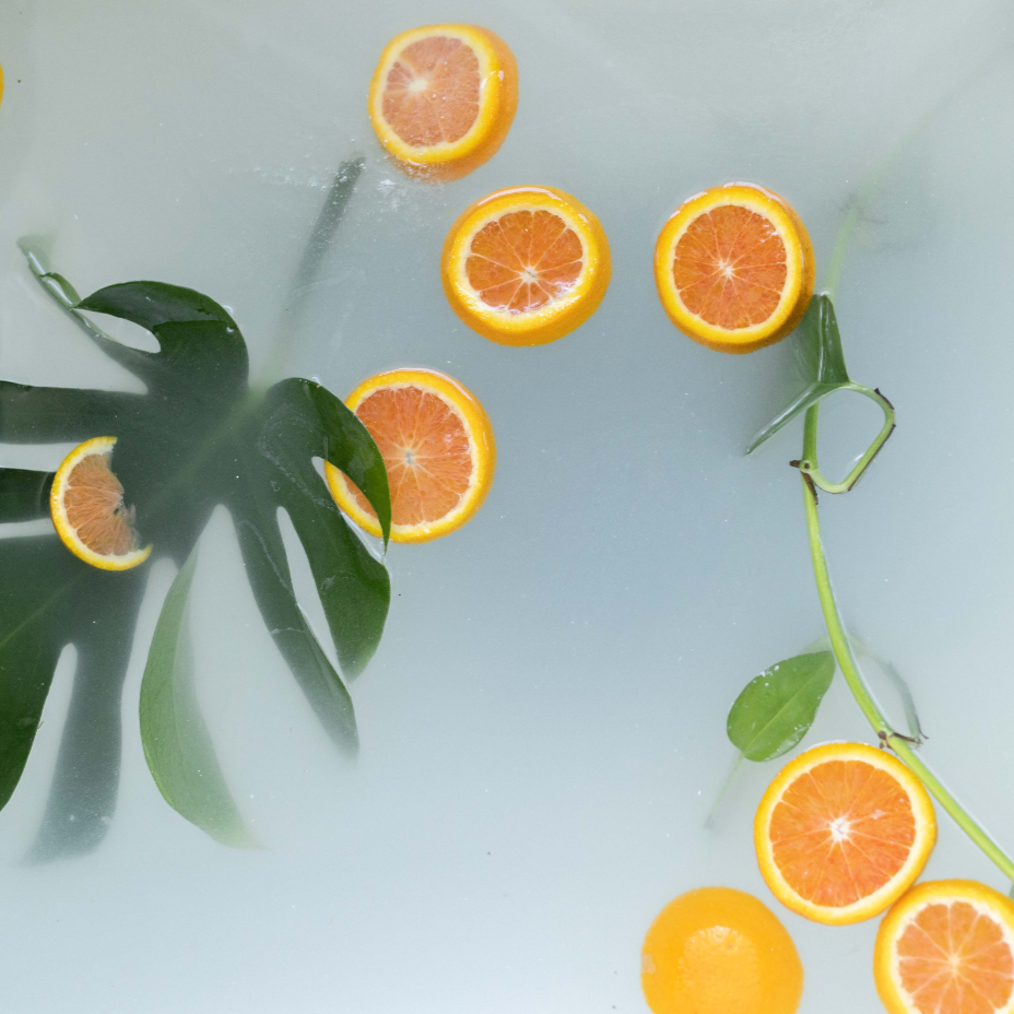 Bath Water After the Fizz of a Bubbles & Balms bath bomb with fronds and orange slices