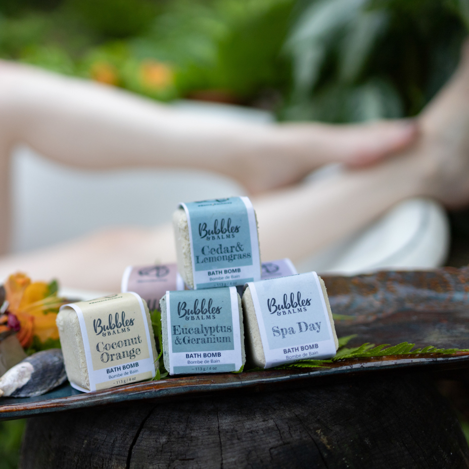 Bubbles &amp; Balms Bath Bomb Collection With Women in Clawfoot Tub Posed Behind Them near Hampton, New Brunswick