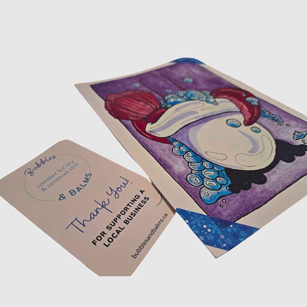 Woman breaking off a section of bubble tab to mix and match aromas with a section from another bubble tab from the Bubble Bath Therapy for Dry Skin kit from Bubbles &amp; Balms