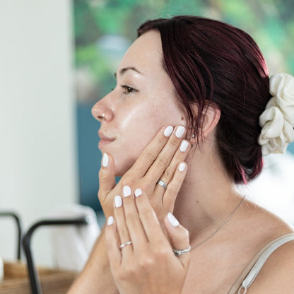 Bubbles &amp; Balms Tea Tree &amp; Safflower Night Cream for Oily &amp; Blemished Skin being applied to face of model.