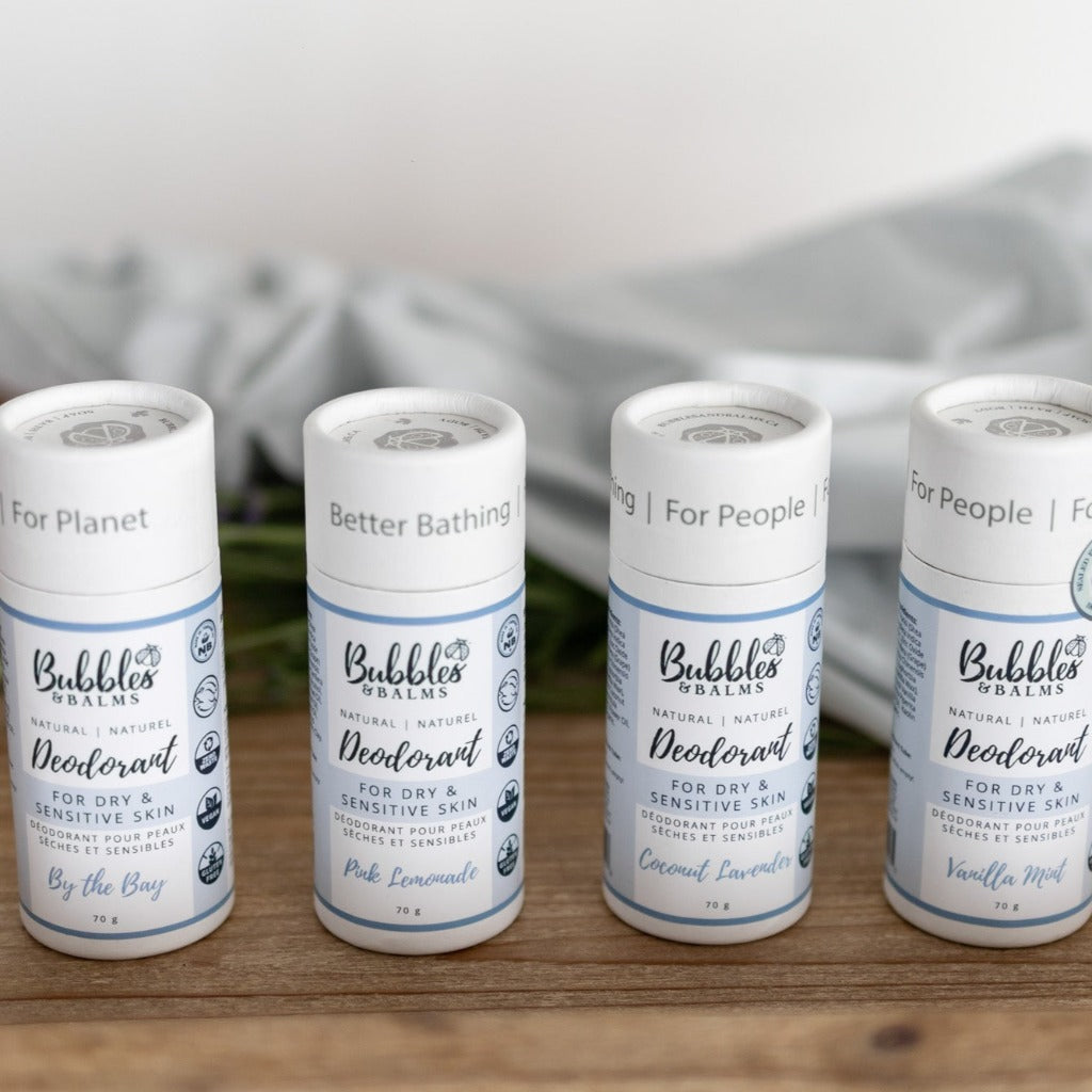 Bubbles &amp; Balms collection of natural deodorants for dry &amp; sensitive skin on a wooden table.