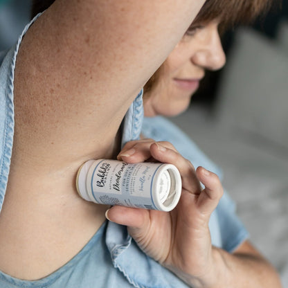 Woman applying Bubbles &amp; Balms natural Vanilla Mint deodorant.