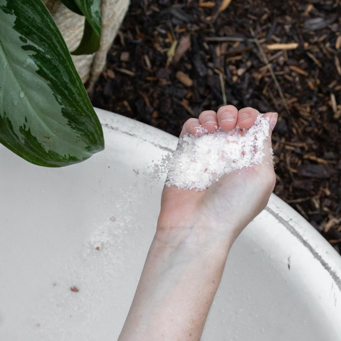 Bubbles &amp; Balms bath salts in hand in tub