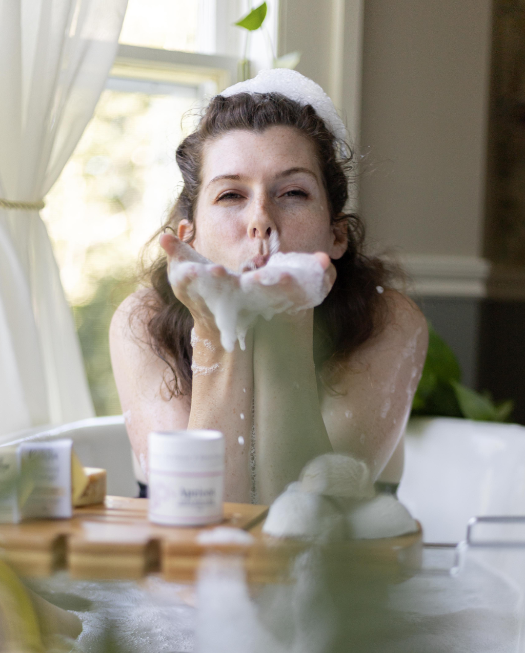 Bubbles & Balms zero-waste bubble bath for dry & sensitive skin making big bubbles in tub and safe enough for face to get close and blow bubble kisses.